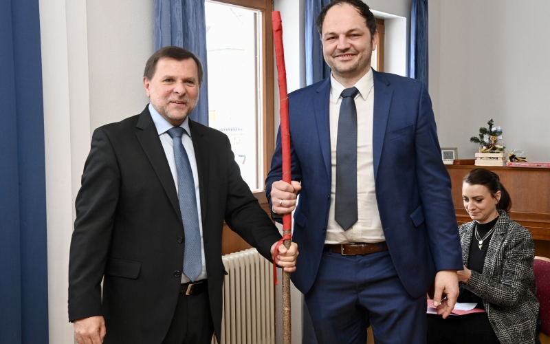 Zwei Personen mit Stab