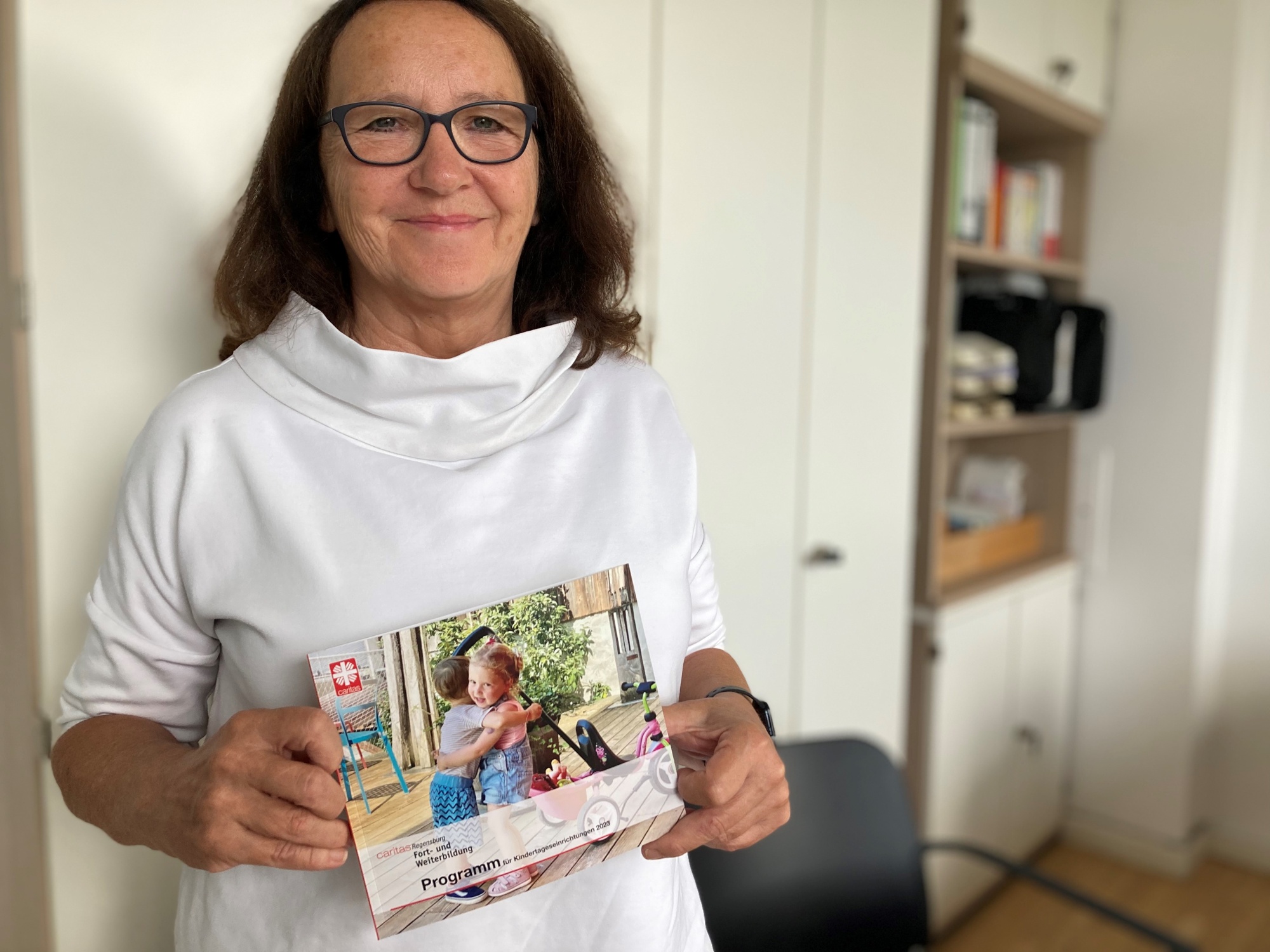 Frau hält Flyer in der Hand